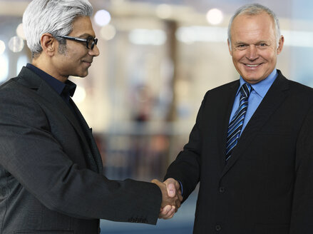 Portrait of two business partners shaking hands - STKF000518