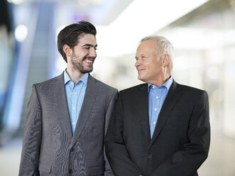 Portrait of two business men looking at each other - STKF000534