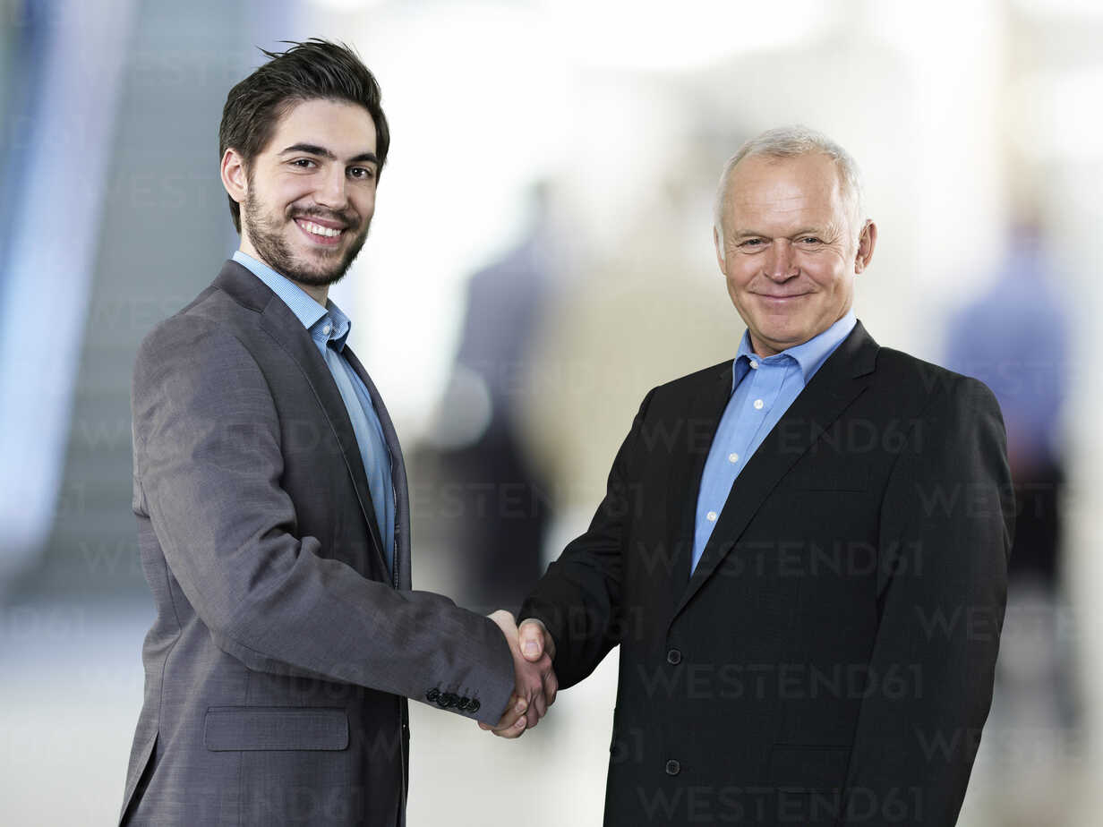 Portrait of two business men shaking hands stock photo