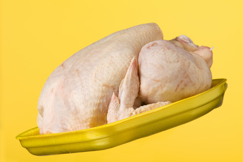 Chicken on yellow plastic plate stock photo