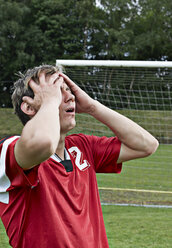 Frustrated soccer player on field - STKF000676