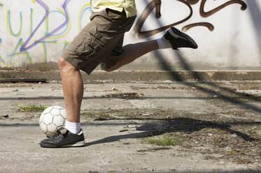 Man playing street soccer - STKF000682