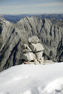 Austria, Tyrol, Karwendel mountains, Stack of stones in snow - TKF000189