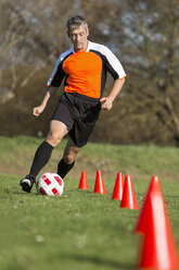 Fußballspieler beim Durchlaufen eines Slalomkurses - STSF000221