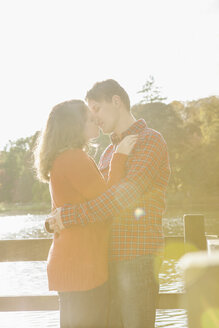 Happy young couple kissing at lake - BGF000013