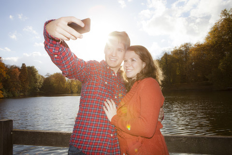 Happy young couple photographing themself stock photo