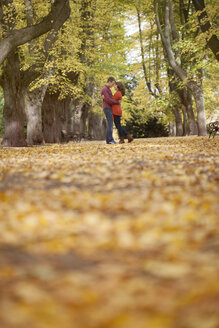 Happy young couple enjoying autumn in a park - BGF000031