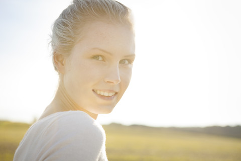 Portrait of smiling young woman, close-up stock photo