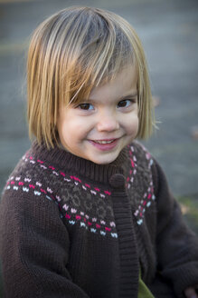 Portrait of smiling little girl wearing cardigan - LVF000333
