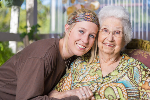 Aged woman and her great-granddaughter side by side - ABAF001076