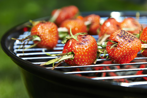 Grilled strawberries spicked with rosmary stock photo