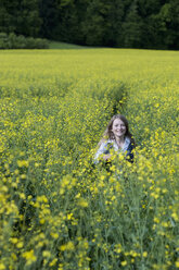 Germany, Bavaria, Starnberg, girl in a rape field - CRF002517