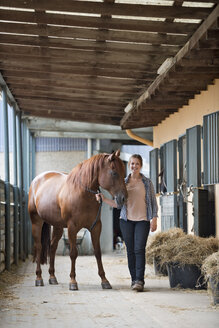 Germany, NRW, Korchenbroich, Young woman with her horse - CLPF000015