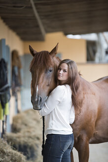 Germany, NRW, Korchenbroich, Young woman with her horse - CLPF000014