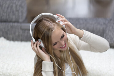 Portrait of smiling young woman with headphones - DRF000295