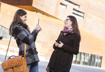 Two young women using digital tablet outdoors - DISF000226