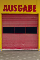 Germany, part of facade with red roller shutter of a wrapping counter - VI000008
