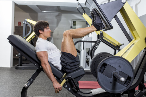 Österreich, Klagenfurt, Mann im Fitnesscenter beim Gerätetraining, lizenzfreies Stockfoto