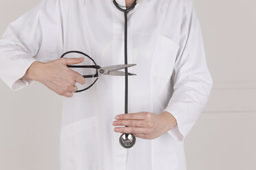 Doctor in doctor's overall cutting stethoscope - DRF000321