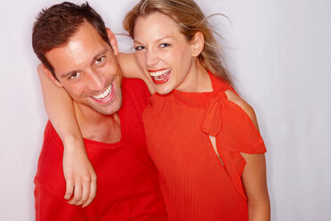 Portrait of happy young couple dressed in red - CHAF000118