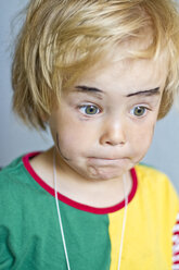 Portrait of little girl making a face - JFEF000255