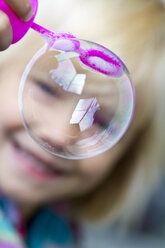 Smiling little girl with soap bubble - JFEF000243