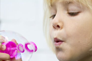 Portrait of little girl making soap bubbles - JFEF000246