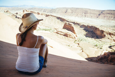 USA, Utah, young woman enjoying the view in Arches National Park, back view - MBEF001031