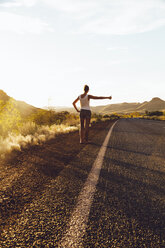 Australia, Young woman hitchhiking - MBEF001004