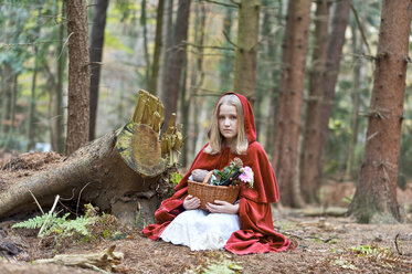 Mädchen als Rotkäppchen verkleidet auf dem Boden sitzend im Wald - CLPF000039
