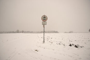 Snow covered landscape with traffic sign at field path - WGF000153