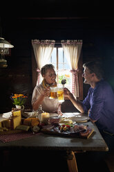 Austria, Salzburg State, Altenmarkt-Zauchensee, couple having an alpine picnic at alpine cabin - HHF004724