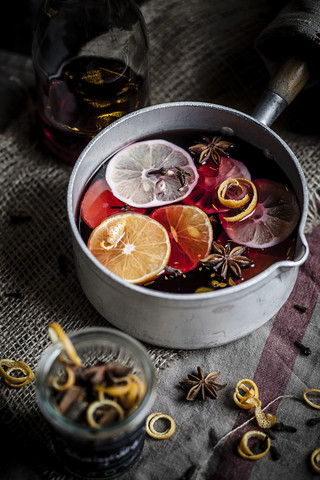 Casserole with mulled wine, slices of lemons and oranges and spices stock photo