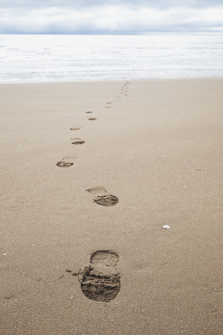 New Zealand, Coromandel Peninsula, foot traces on beach stock photo