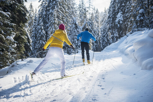 Österreich, Salzburger Land, Altenmarkt-Zauchensee, Junges Paar beim Skilanglauf - HHF004658