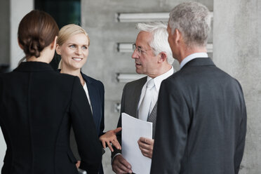 Four businesspeople talking in office - CHAF000011