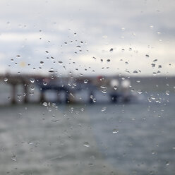 Germany, Schleswig-Holstein, Heiligenhafen, raindrops on window. pier - WIF000246
