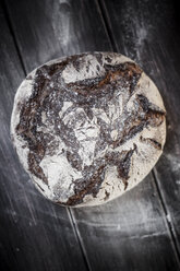 Rye-Spelt-Malt loaf and flour on wooden table - SBDF000428