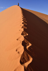 Algeria, Sahara, Tassili N'Ajjer National Park, Tadrart, woman hiking a dune of Tin Merzouga - ES000883