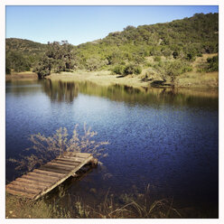 Landscape photograph of fishing pond with wooden deck. Texas, United States - ABAF001133