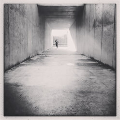 Toddler running through a square footwalk tunnel, Germany, Berlin, - ZMF000042