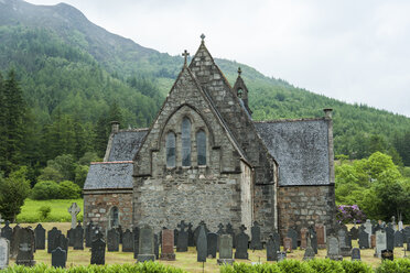 UK, Scotland, Glen Coe, Ballachulish, view to St John's church with tombstones of cemetery in front - PA000225