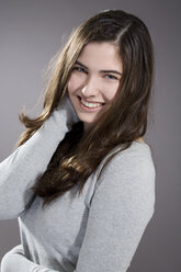 Portrait of smiling young woman, studio shot - MAEF007618