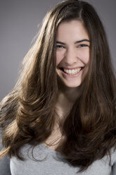 Portrait of laughing young woman, studio shot - MAEF007620