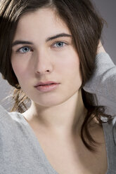 Portrait of daydreaming young woman, studio shot - MAEF007622