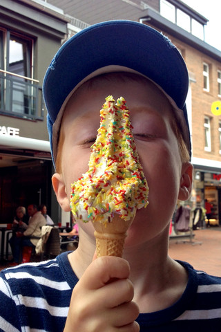 Boy eating soft ice cream, Germany, Schleswig Holstein, Schleswig stock photo