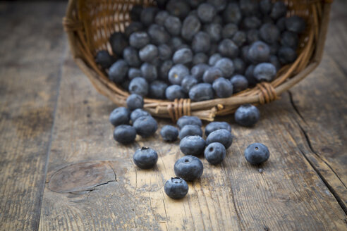 Part of wickerbasket with blueberries (Vaccinium myrtillus) on wooden table - LVF000434