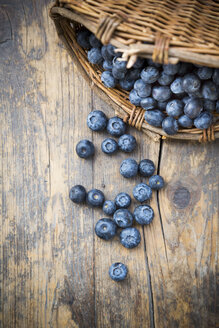Part of wickerbasket with blueberries (Vaccinium myrtillus) on wooden table - LVF000433