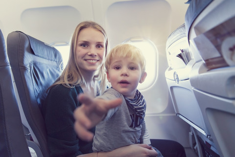 Mother with son in airplane stock photo