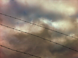 Barbed wire, fence, dramatic skies, Ecuador - ONF000352